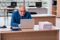 Old male boss employee working in the office Royalty Free Stock Photo