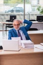 Old male boss employee working in the office Royalty Free Stock Photo