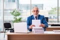 Old male boss employee working in the office Royalty Free Stock Photo