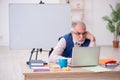 Old male designer working in the office Royalty Free Stock Photo