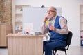 Old male designer working in the office Royalty Free Stock Photo