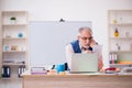 Old male designer working in the office Royalty Free Stock Photo