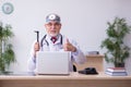 Old male doctor otologist working in the clinic