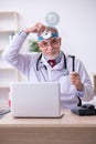 Old male doctor otologist working in the clinic