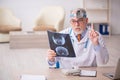 Old male doctor otologist working in the clinic