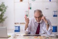 Old drug addicted employee sitting in the office Royalty Free Stock Photo