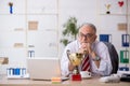 Old male employee being awarded with golden cup Royalty Free Stock Photo