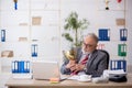 Old male employee being awarded with golden cup Royalty Free Stock Photo