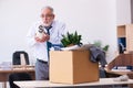 Old male employee being fired from his work in retirement concept