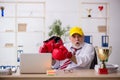 Old male employee boxer being awarded with golden cup