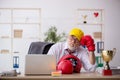 Old male employee boxer being awarded with golden cup