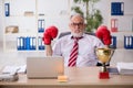 Old male employee boxer being awarded with golden cup