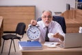 Old male employee in time manegement concept Royalty Free Stock Photo