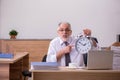 Old male employee in time manegement concept Royalty Free Stock Photo