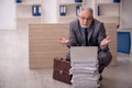 Old male employee and too much work in the office Royalty Free Stock Photo