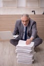 Old male employee and too much work in the office Royalty Free Stock Photo