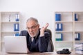 Old male employee working in the office Royalty Free Stock Photo