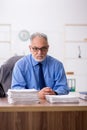 Old male employee working in the office Royalty Free Stock Photo