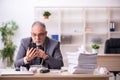 Old male employee working at workplace Royalty Free Stock Photo