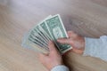 Old male hands hold paper dollars banknotes in his hands, counting a bundle of money, concept of cash, payments, savings Royalty Free Stock Photo