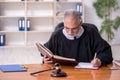 Old male judge working in courthouse Royalty Free Stock Photo