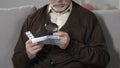 Old male with magnifying glass reading pills dosage and precautions, treatment