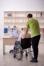 Old patient in wheel-chair visiting skeleton doctor Royalty Free Stock Photo