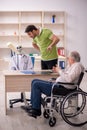 Old patient in wheel-chair visiting skeleton doctor Royalty Free Stock Photo
