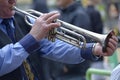 Old male street musician hands play the trumpet