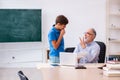 Old male teacher and schoolboy in the classroom