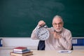 Old male teacher in time management concept Royalty Free Stock Photo