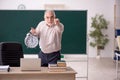 Old male teacher in time management concept Royalty Free Stock Photo