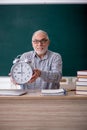 Old male teacher in time management concept Royalty Free Stock Photo