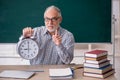 Old male teacher in time management concept Royalty Free Stock Photo