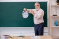 Old male teacher in time management concept Royalty Free Stock Photo