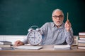 Old male teacher in time management concept Royalty Free Stock Photo