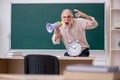 Old male teacher in time management concept Royalty Free Stock Photo