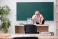 Old male teacher in time management concept Royalty Free Stock Photo