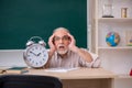 Old male teacher in time management concept Royalty Free Stock Photo