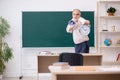 Old male teacher in time management concept Royalty Free Stock Photo