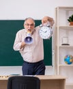 Old male teacher in time management concept Royalty Free Stock Photo