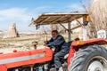 An old male Turkish farmer driving a tractor in the town of Goreme, Cappadocia, a historical region of Turkey Royalty Free Stock Photo