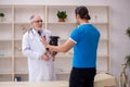 Old male vet doctor examining dog in the clinic Royalty Free Stock Photo