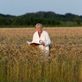 Old man agronomist in barley field Royalty Free Stock Photo