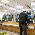 Old Man Alone Paying For Shopping At An Automated Pay Point In Waitrose Supermarket