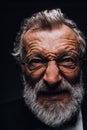 Old man with angry evil horror expression on face, close up on black background Royalty Free Stock Photo