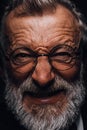 Old man with angry evil horror expression on face, close up on black background
