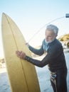 Old man, beach and surfer cleaning surfboard, surfing in Mexico on summer holiday or vacation. Washing, shower and