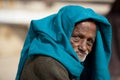 Old man beggar with head scarf begging in India