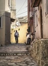 Old man and bike in alley in old, greek village.